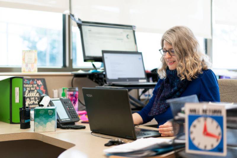 Darla Eimers, a GVSU adult student alum working at her desk